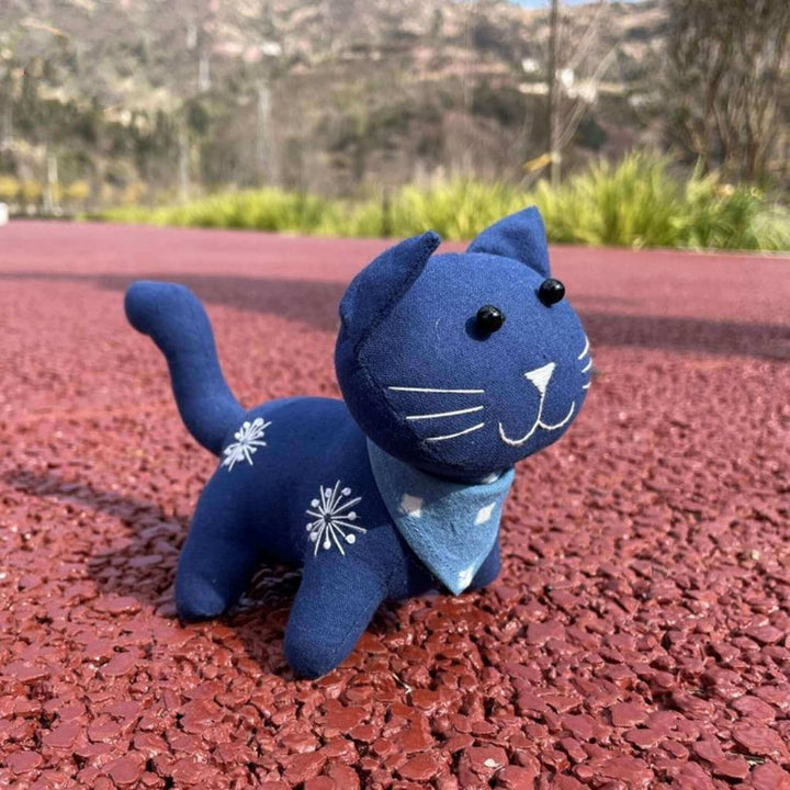 Plant dyed indigo cat toy on the ground, handmade natural cotton fabric stuffed animal doll