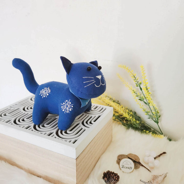 Plant dyed indigo cat toy on a small box, handmade natural cotton fabric stuffed animal doll