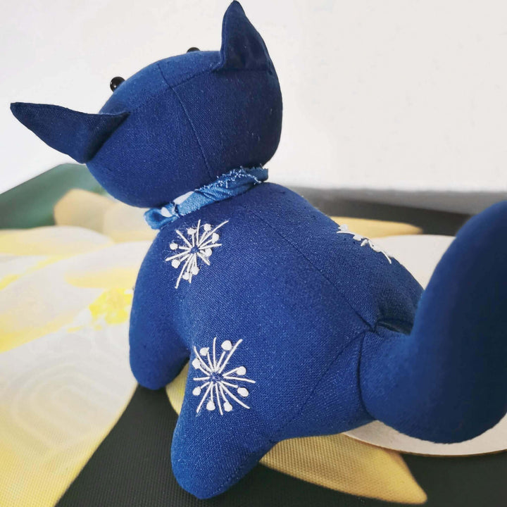 Back view of plant dyed indigo cat toy, showcasing back and embroidery details